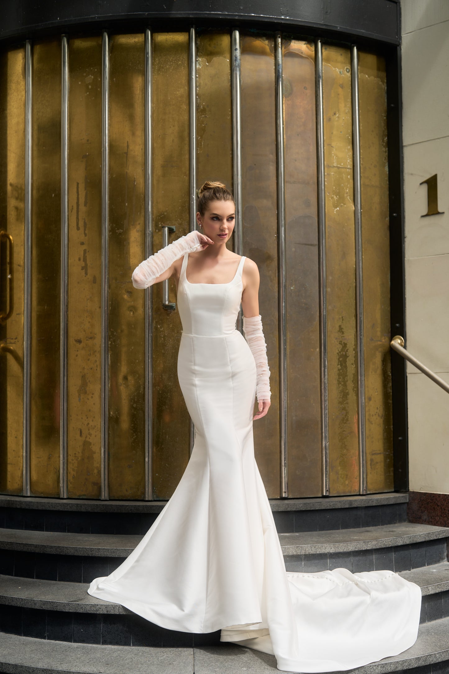 Square neckline fitted wedding dress with sheer pearl sleeves.