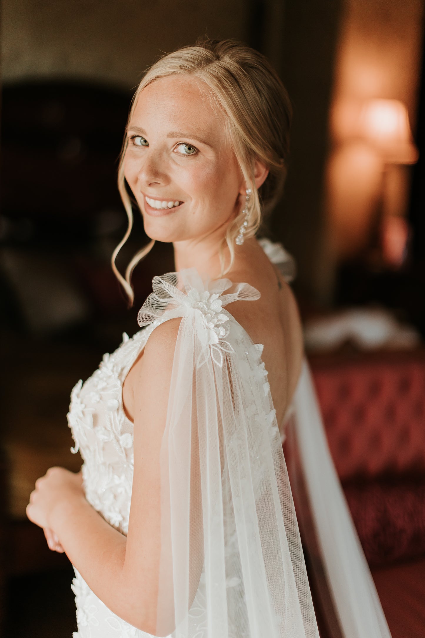 Side angle of bride wearing Saige gown with Saige wings