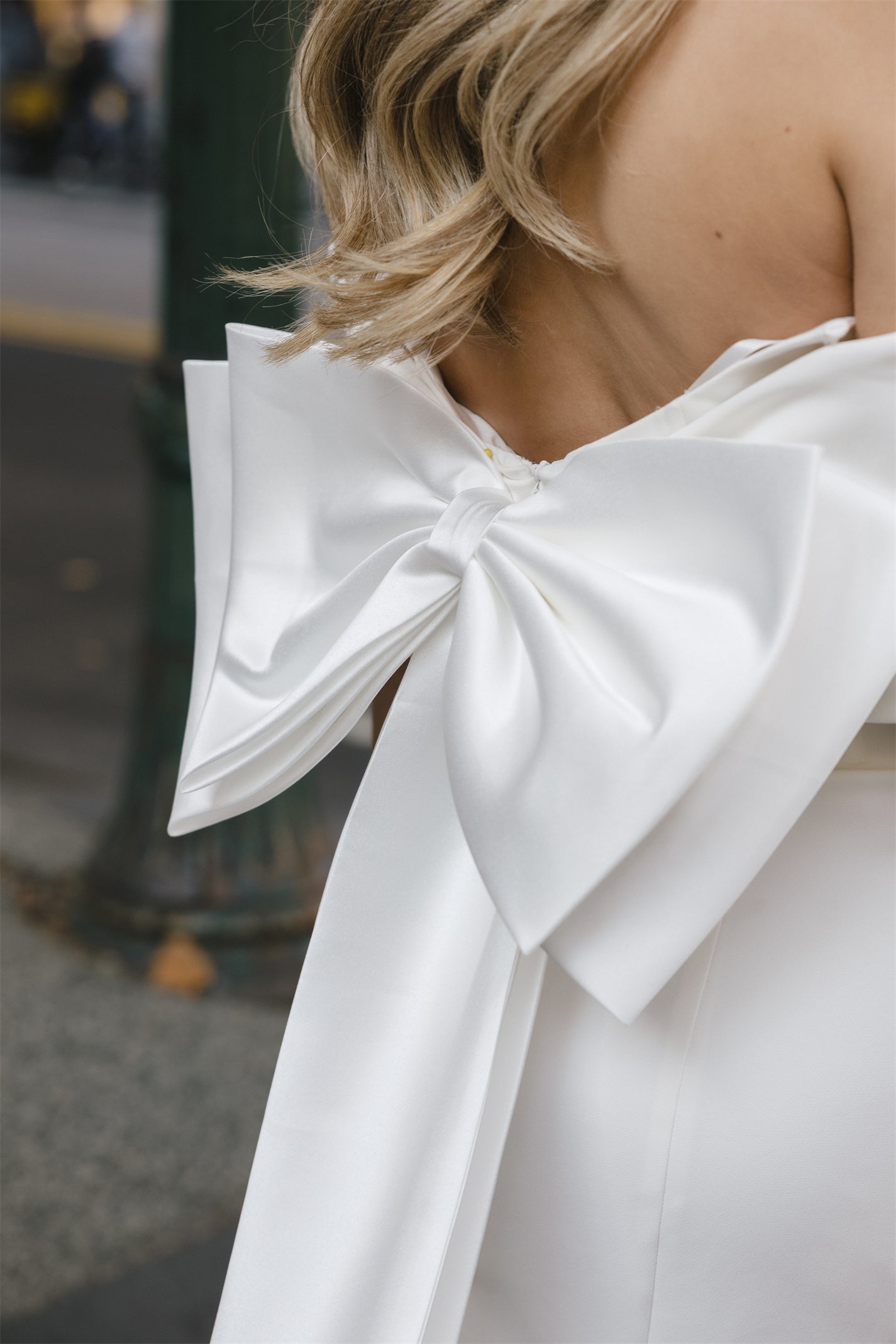 Mini Bridal dress with off-the-shoulder draped sleeves flowing into a full corset bodice, draping into a criss-cross pencil skirt. 