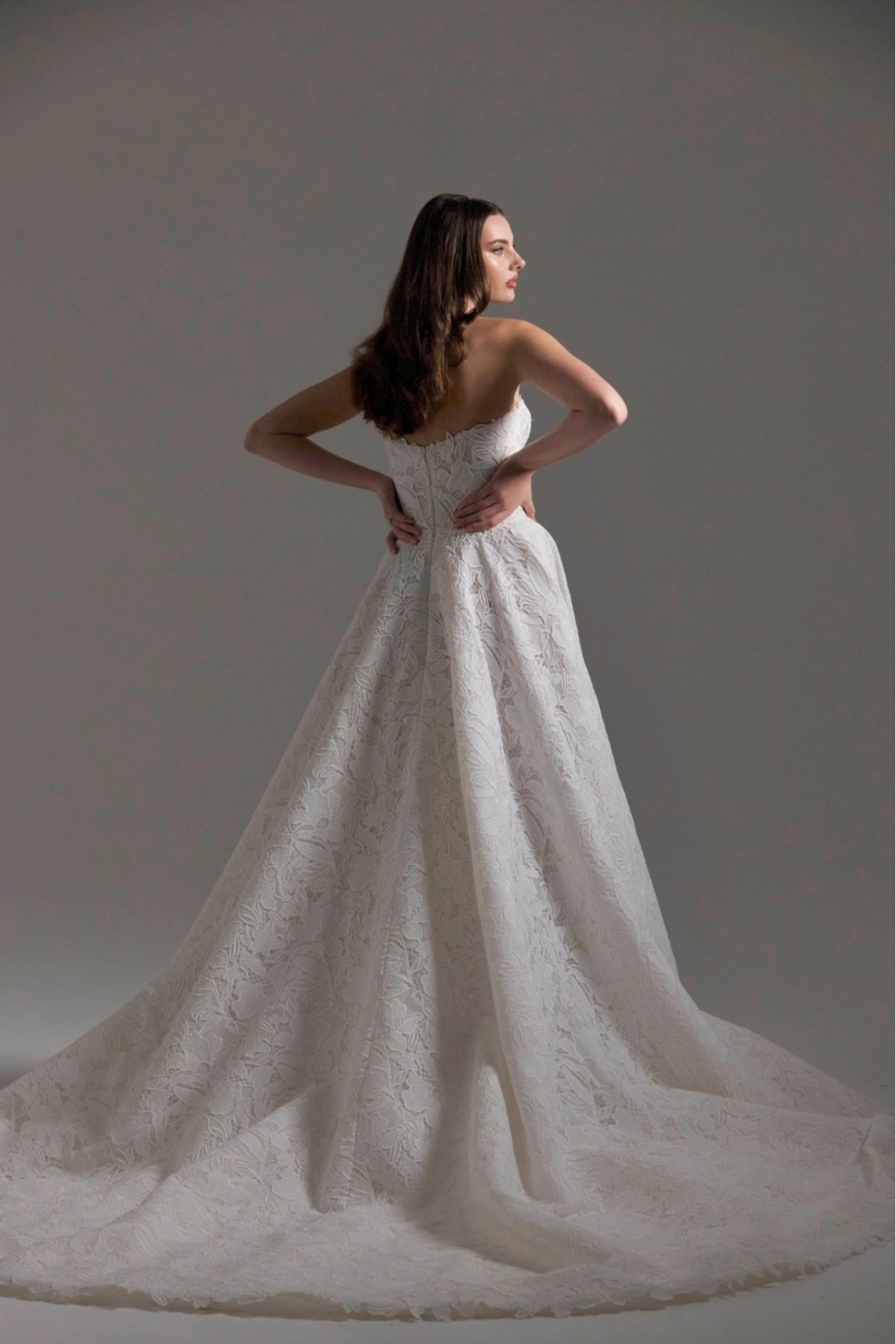 A-line Wedding dress in floral Jacquard fabric with fitted sleeves and a strapless bodice 