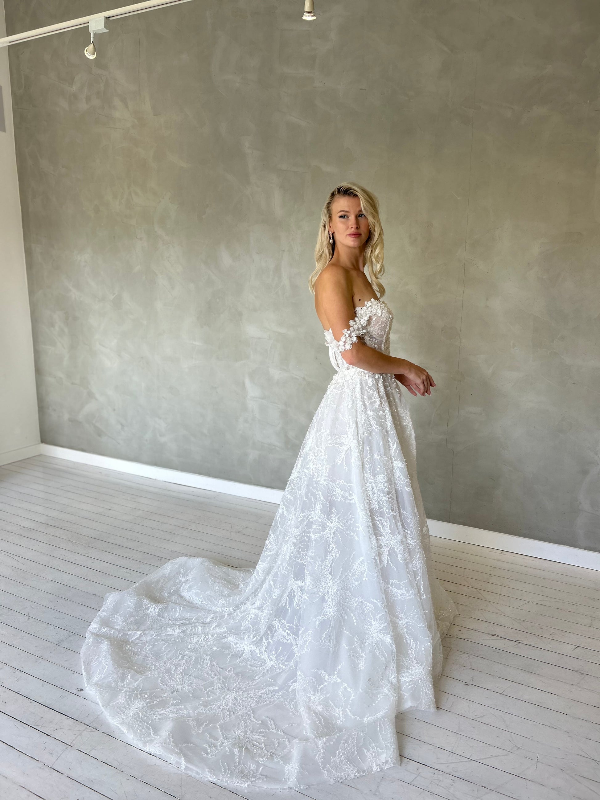mini wedding dress, with off the shoulder straps and a V-plunge Sweetheart bodice. 