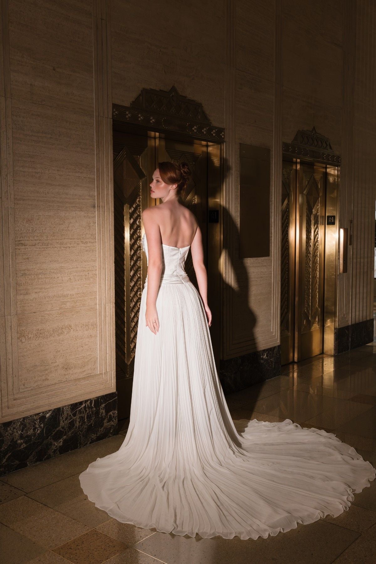 AURELLIA strapless beaded chain-draped satin and chiffon A-line wedding dress, back view with flowing chiffon train, by Atelier Wu
