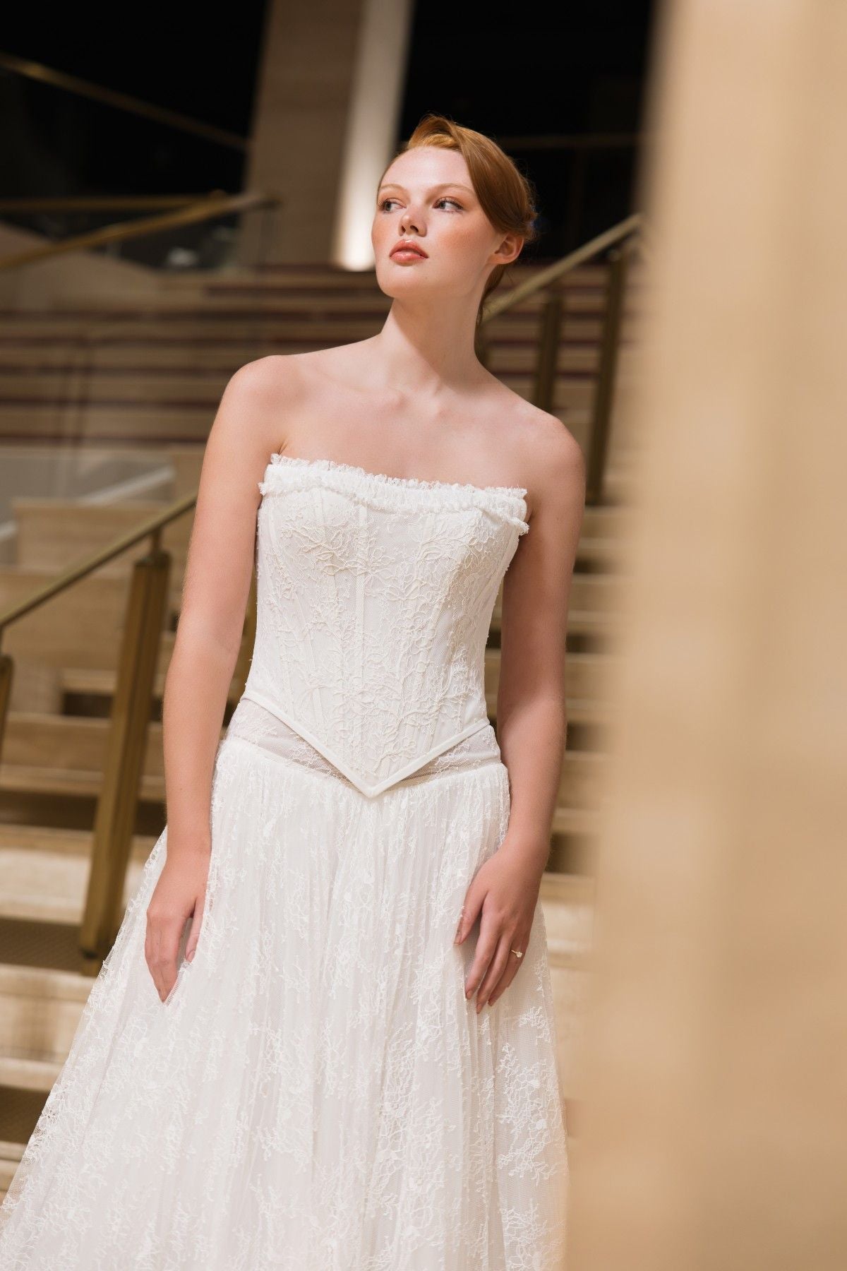 BLAKE strapless lace corset A-line wedding dress with ruffled trim and basque waist, close-up of the ruffle-trimmed corset bodice, by Atelier Wu