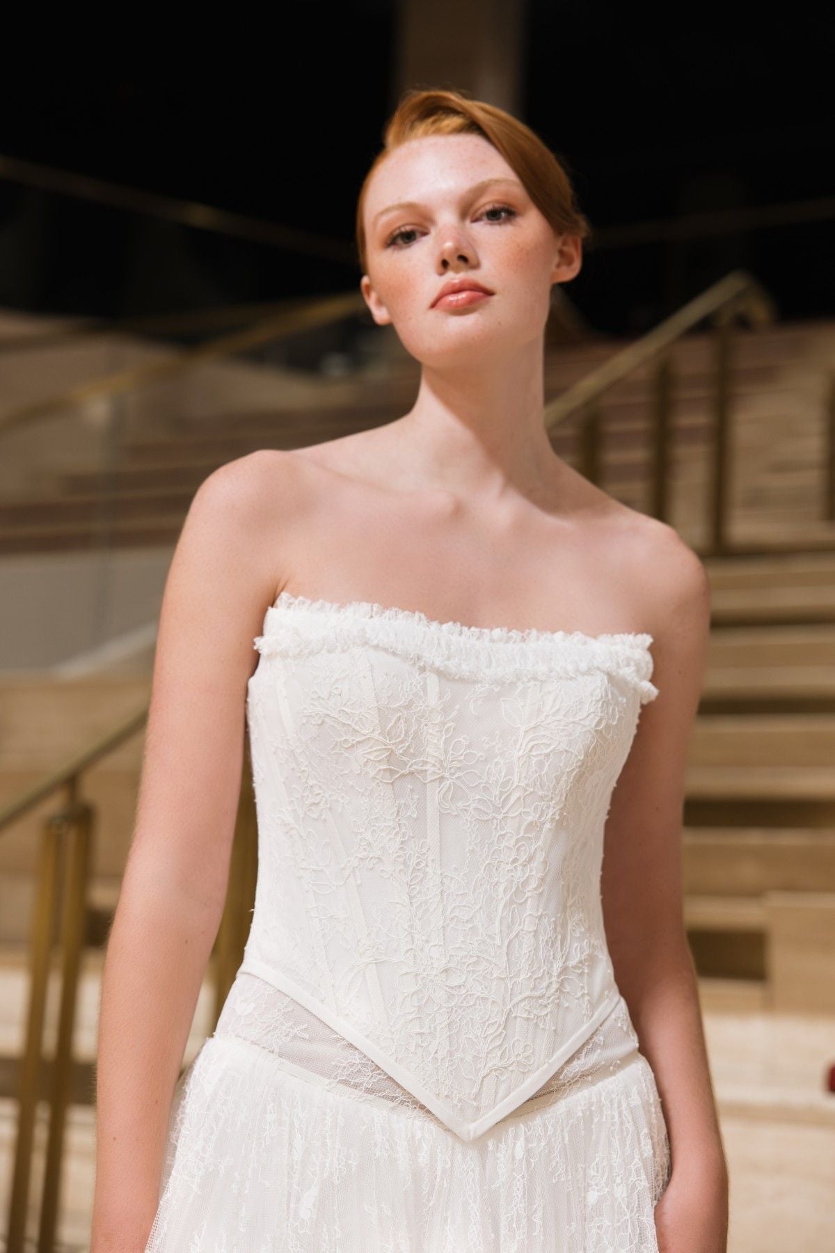 BLAKE strapless lace corset A-line wedding dress with ruffled trim and basque waist, front close-up of the basque waist, by Atelier Wu