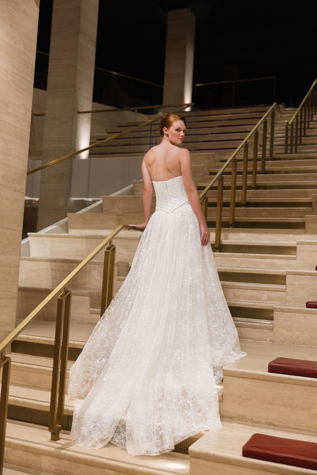 BLAKE strapless lace corset A-line wedding dress with ruffled trim and basque waist, back view with lace train, by Atelier Wu
