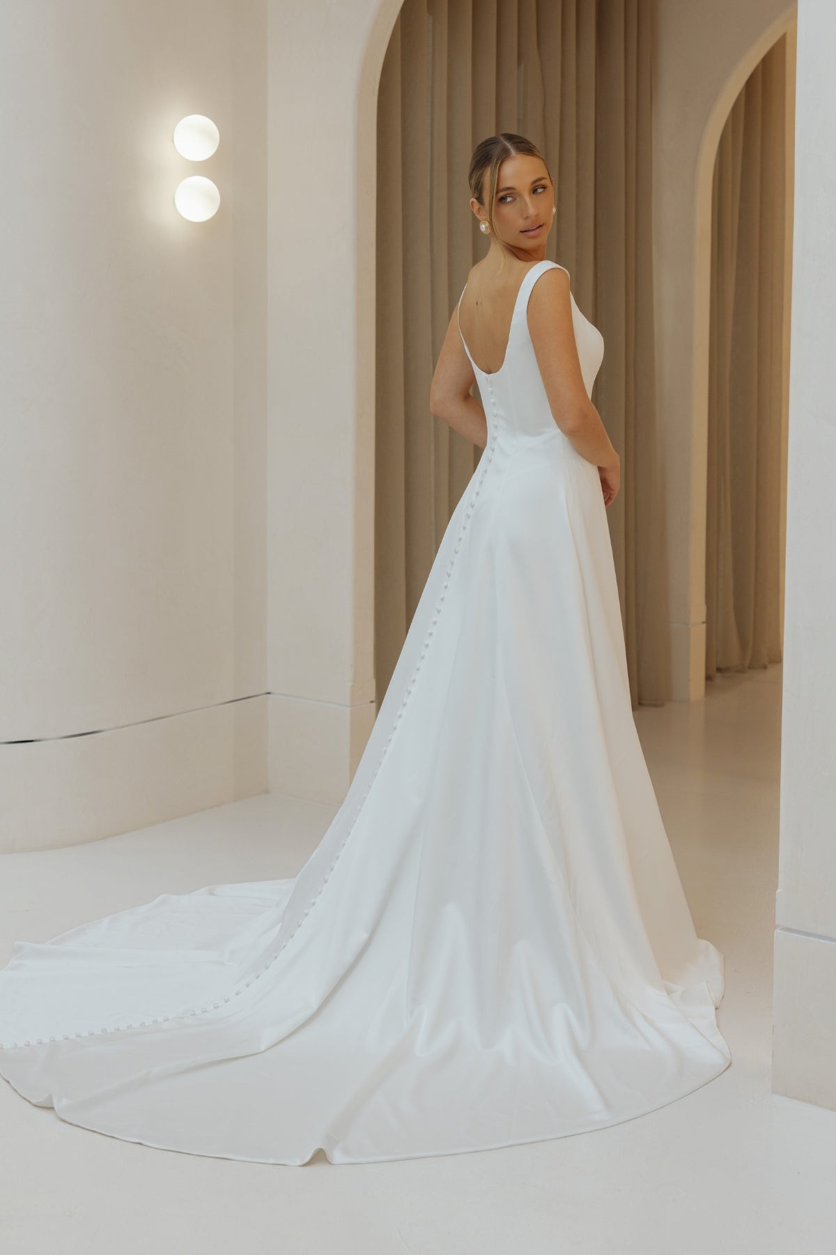Satin A-line sheath wedding gown with square neckline and straps. 