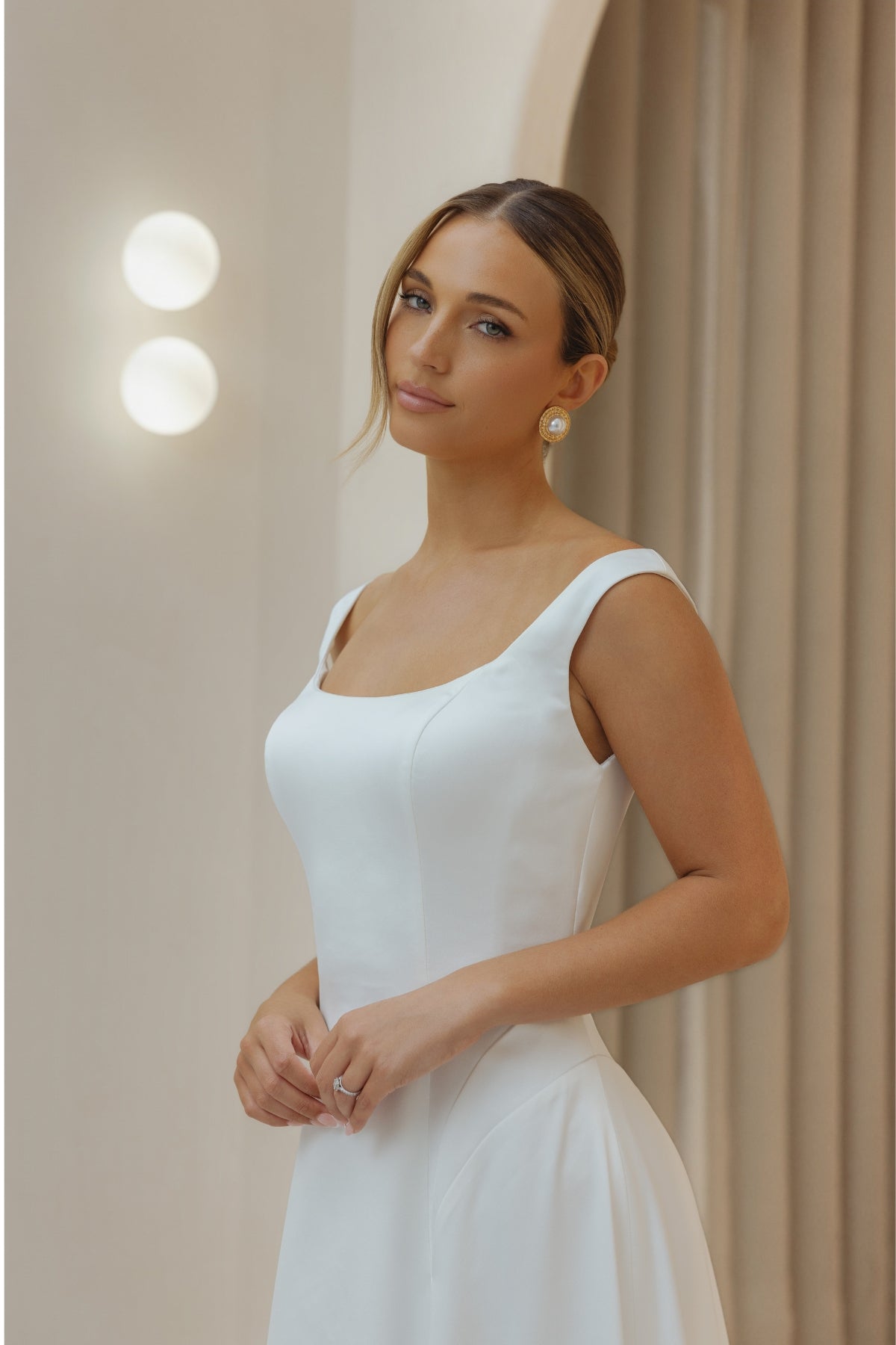Satin A-line sheath wedding gown with square neckline and straps. 