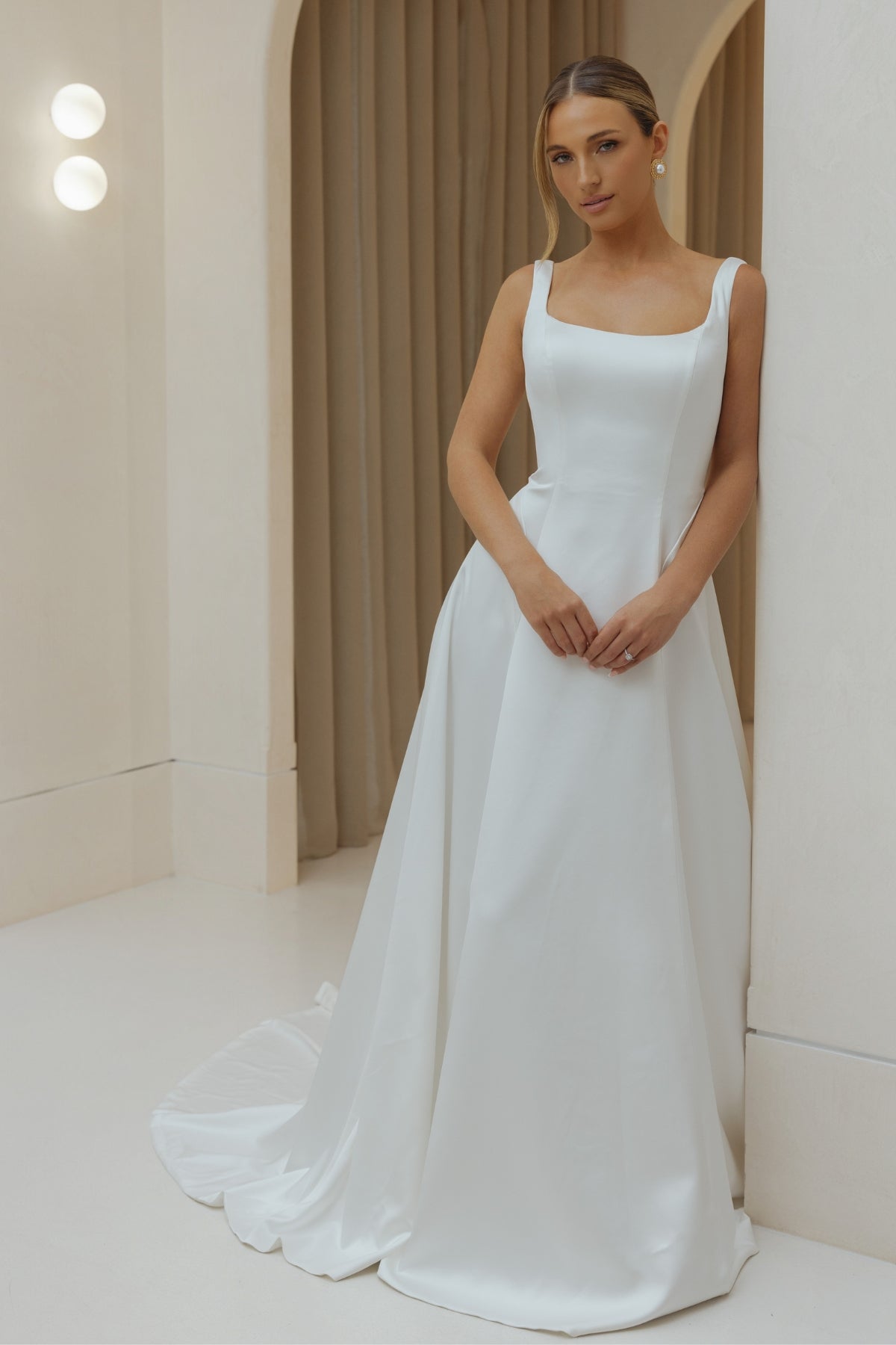 Satin A-line sheath wedding gown with square neckline and straps. 