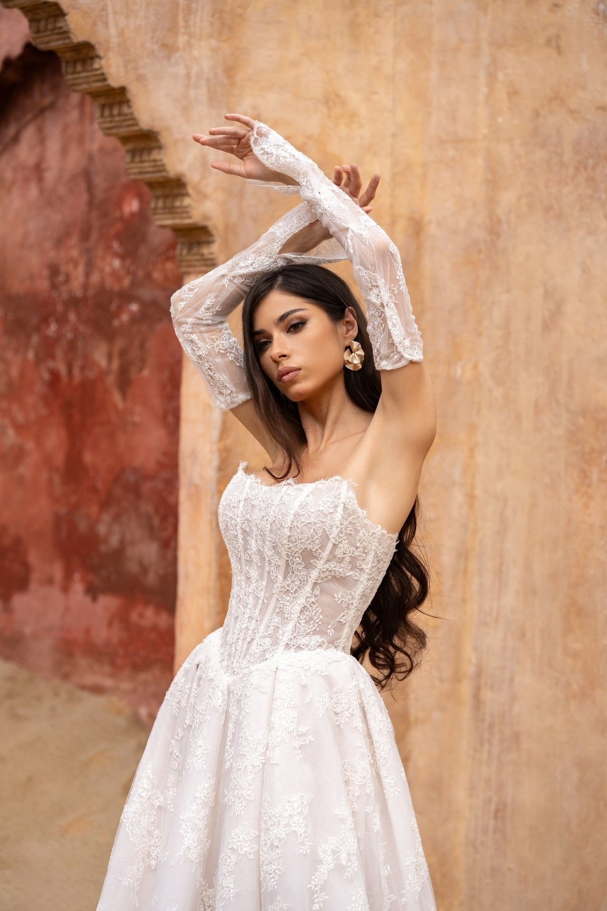 Lace A-line wedding dress with cat-eye neckline and basque waist. paired with fitted lace sleeves. 