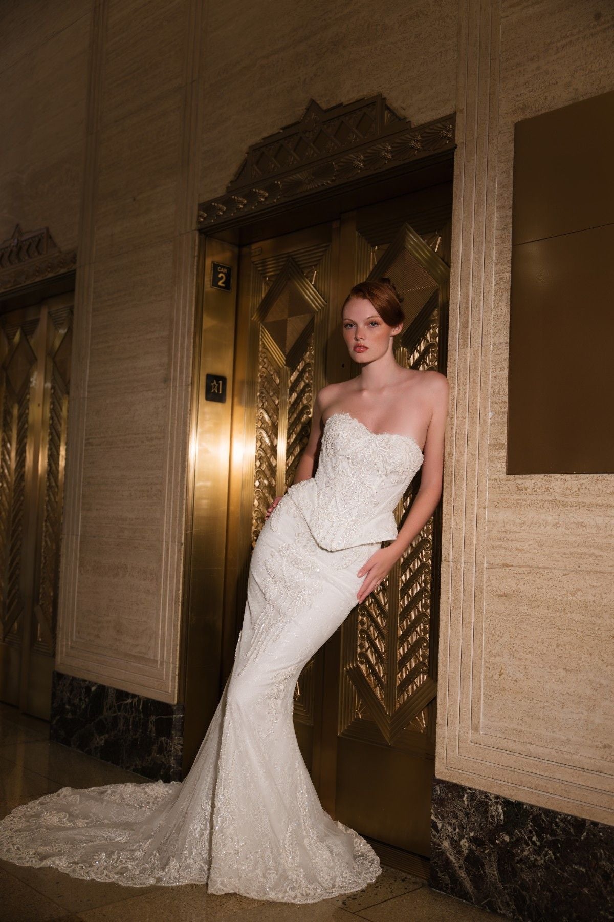 COSETTE strapless beaded lace mermaid wedding dress with peplum waist, side view with sweeping train, by Atelier Wu