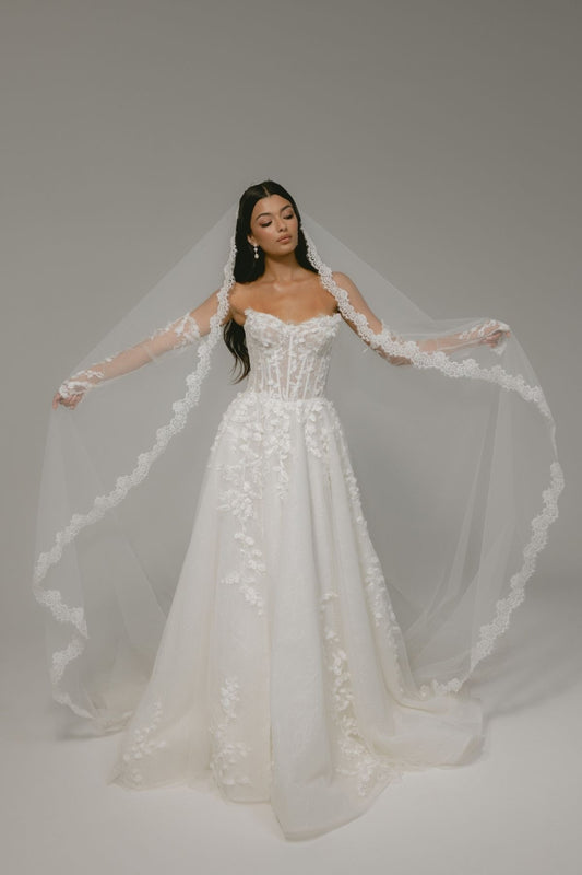 bride wears an elegant mantilla lace veil
