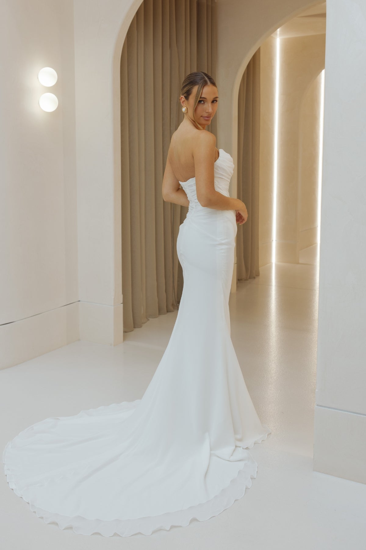 Fitted Bridal gown in draped chiffon, featuring cat-eye neckline