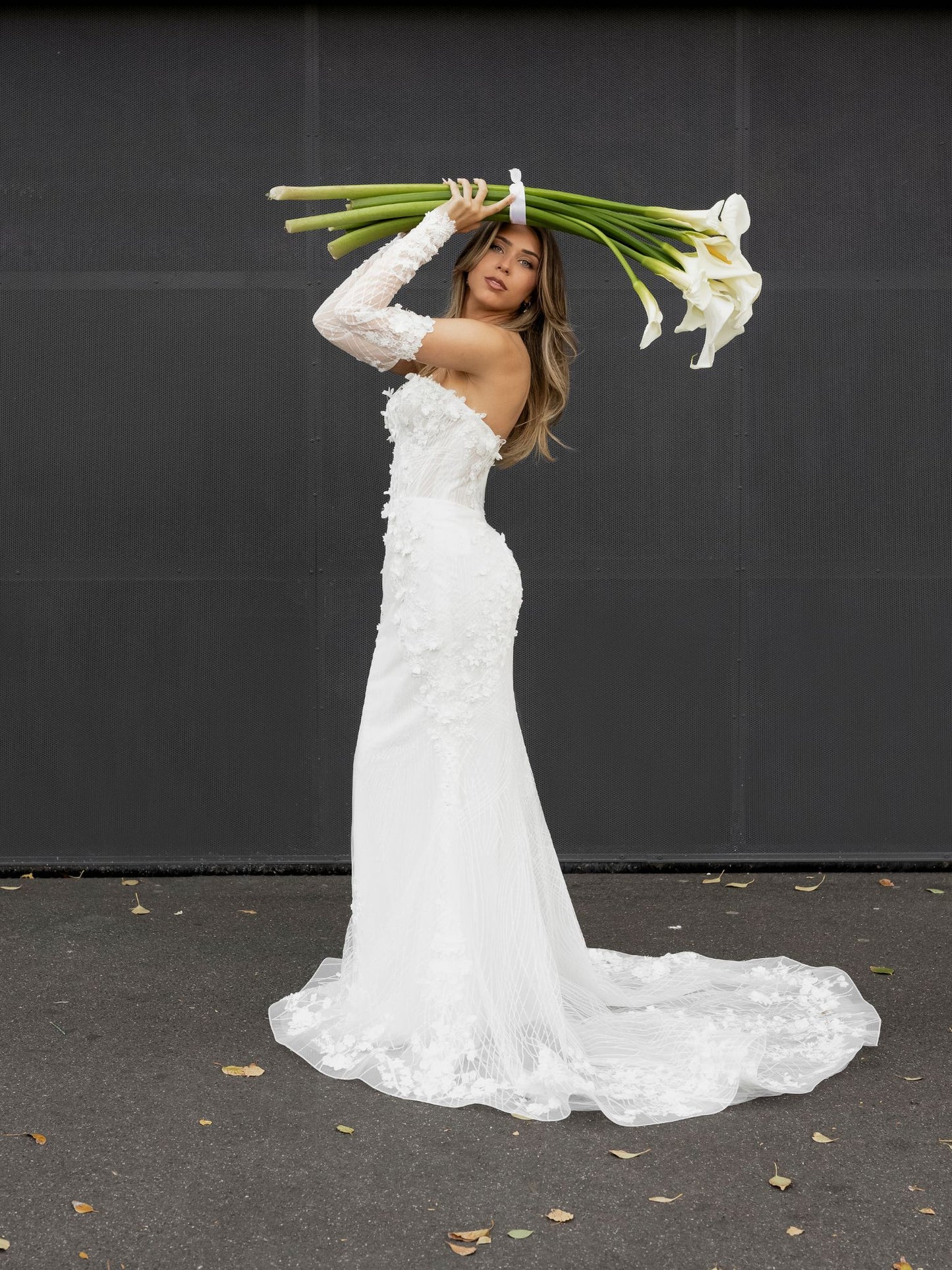 FION Bridal Gown by Windsor Collection Jessica Couture. Fit-n-Flare gown with strapless neckline, fitted gloves, and beaded floral lace. 