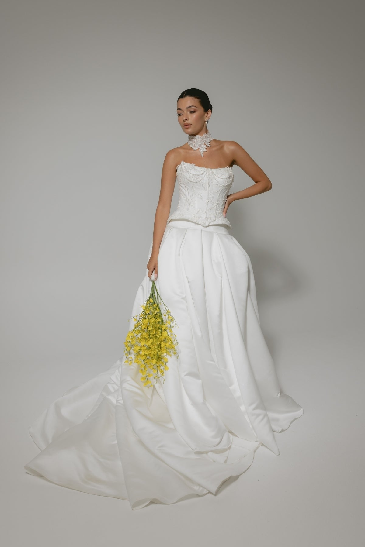 two-piece wedding gown, elaborate corset with hip panels, draped in pearls. paired with a high fashion pleated mikado skirt 