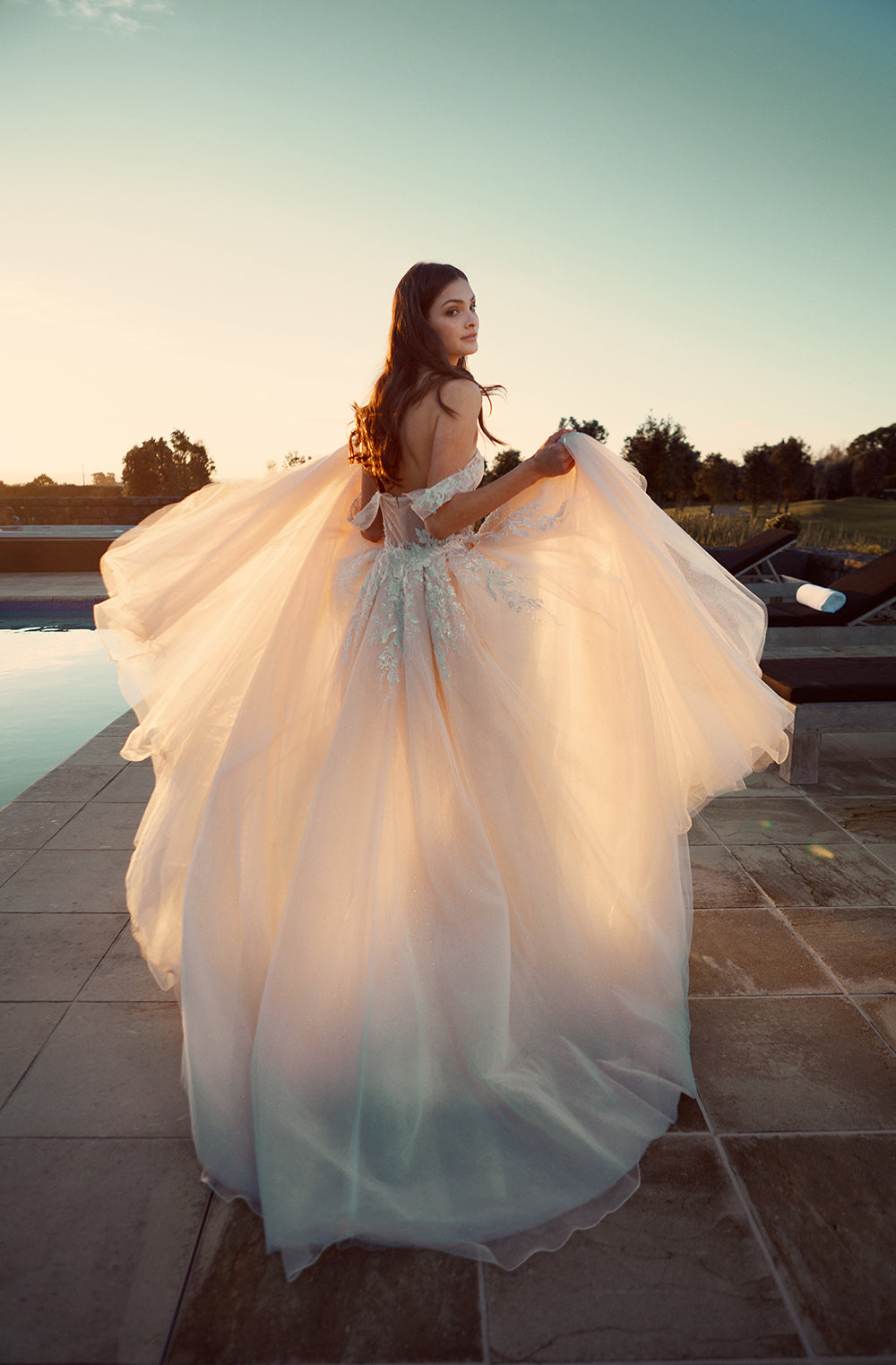Back view of detachable Jamina overskirt. Layers of soft tulle are decorated in lace that drips from the waist 