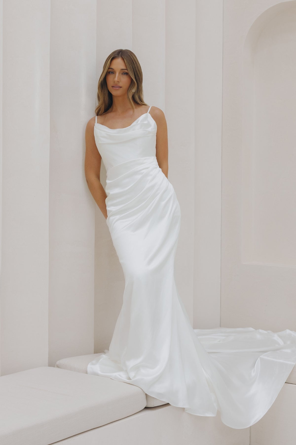 Fitted Bridal gown in Charmeuse, thin spaghetti straps and drape cowl neckline, with hip draping. 