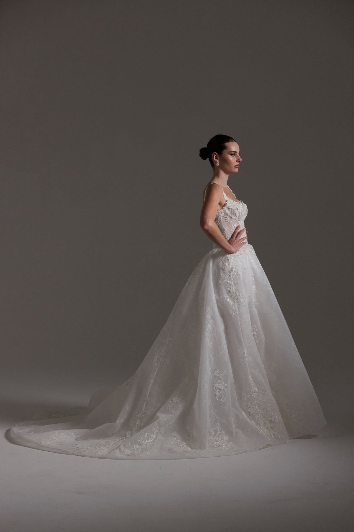 A-line Wedding gown featuring a square neckline, ballgown skirt, and lace. 