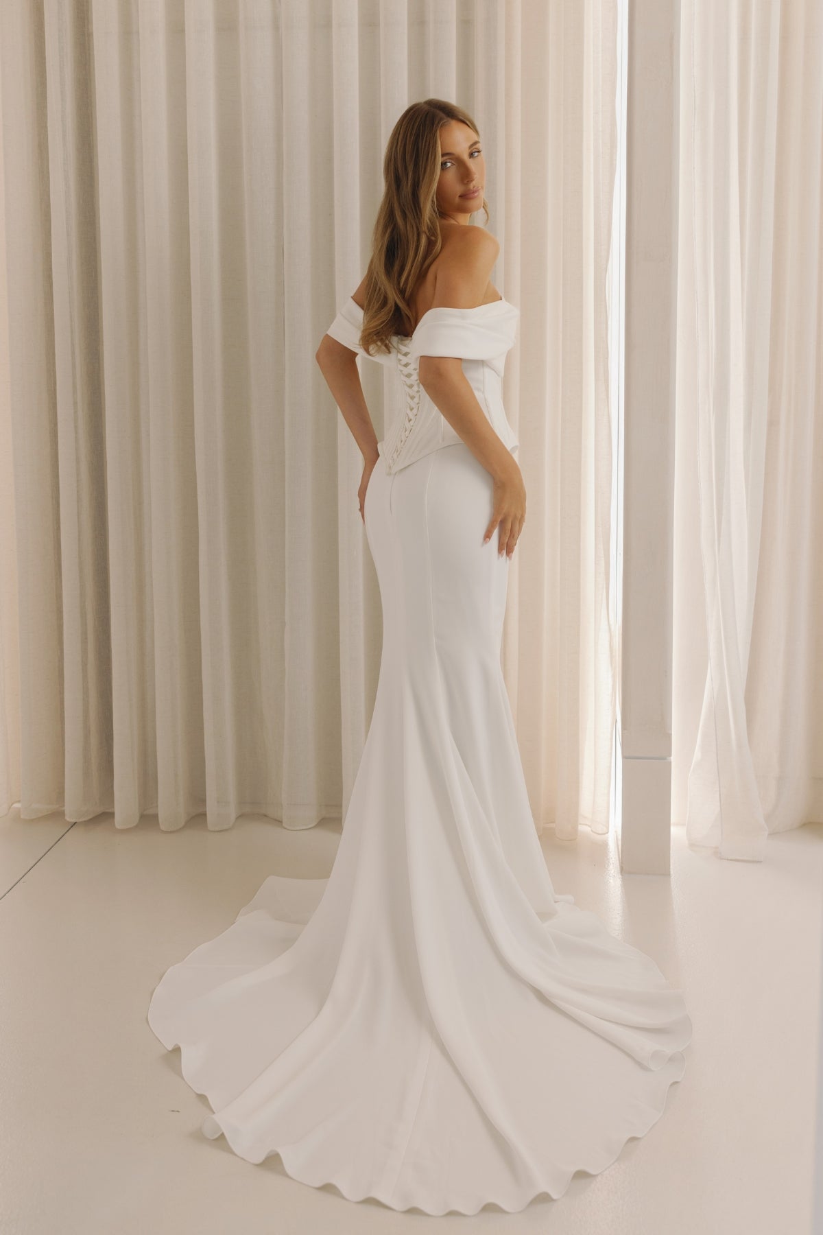 two piece fitted crepe wedding gown, off the shoulder neckline and corseted lace up back. 
