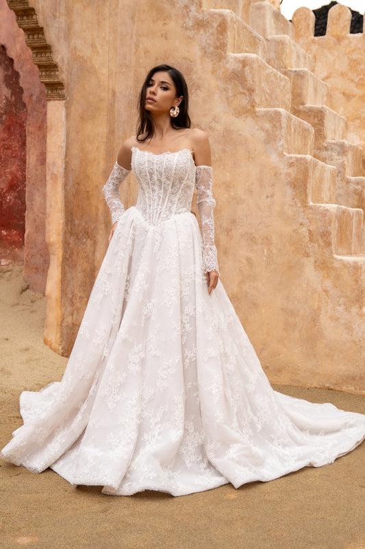Lace A-line wedding dress with cat-eye neckline and basque waist. paired with fitted lace sleeves. 