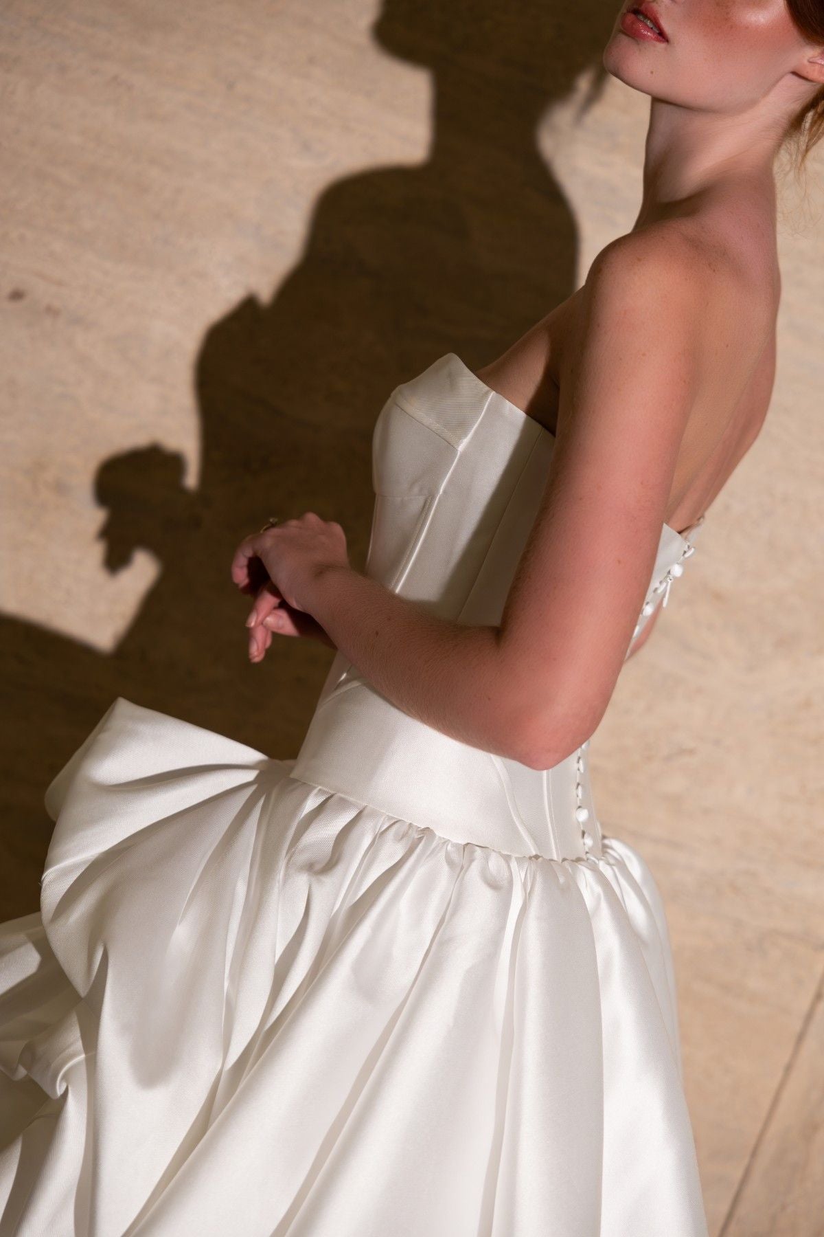 SIDONIE strapless sweetheart mikado ballgown wedding dress with draped pick-up skirt, close-up of the draped mikado skirt, by Atelier Wu