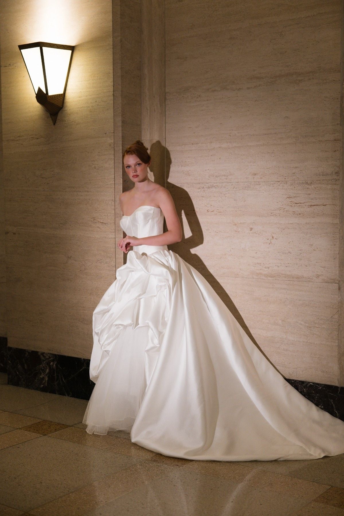 SIDONIE strapless sweetheart mikado ballgown wedding dress with draped pick-up skirt, full-length side view with train, by Atelier Wu
