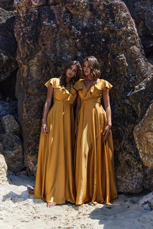 Bridesmaid gown with crossover neckline and frill. Full-length skirt. Shown here in honey satin