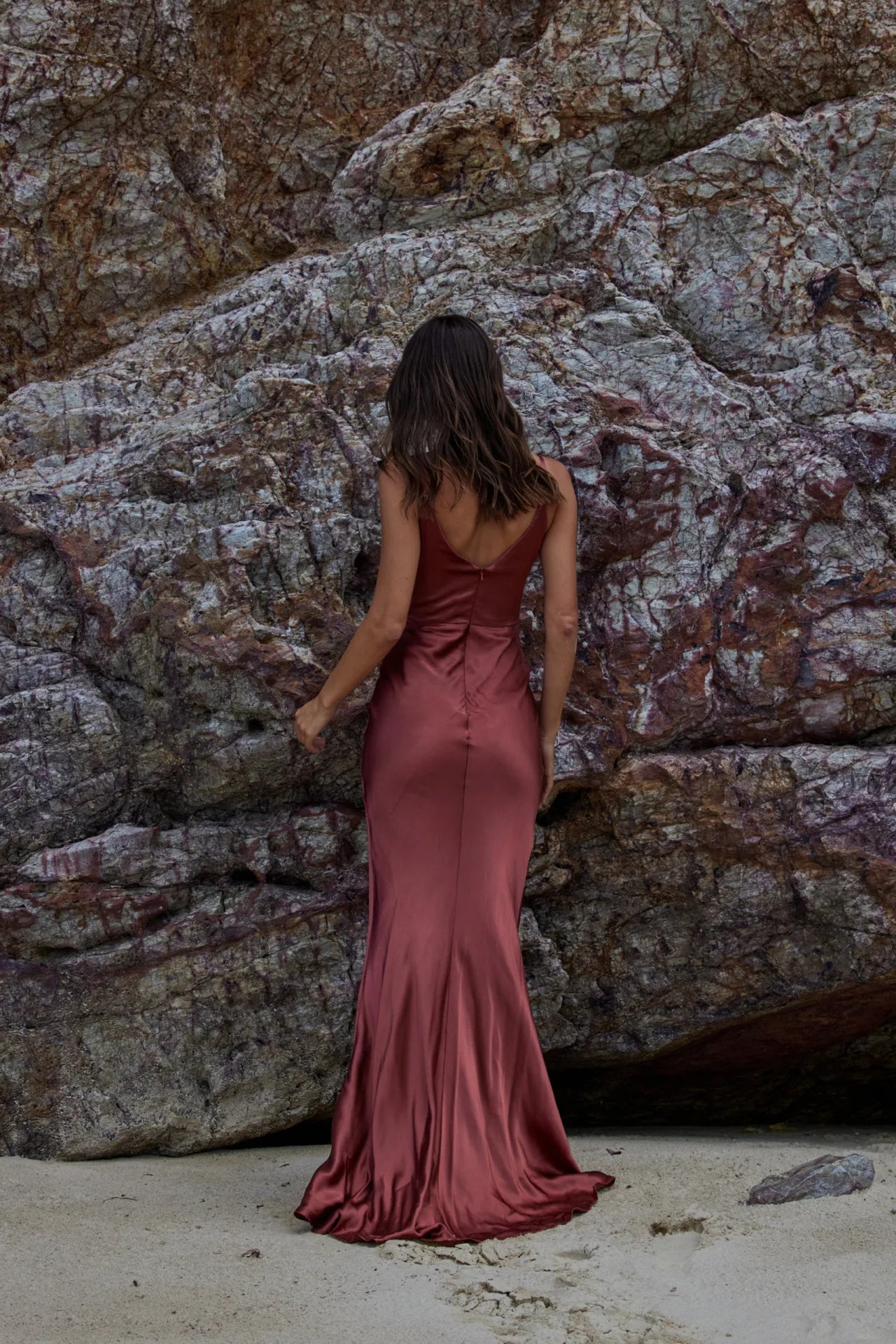 Back view of Misty bridesmaid dress in rust colour satin-look fabric. Full length dress with centre back zip closure