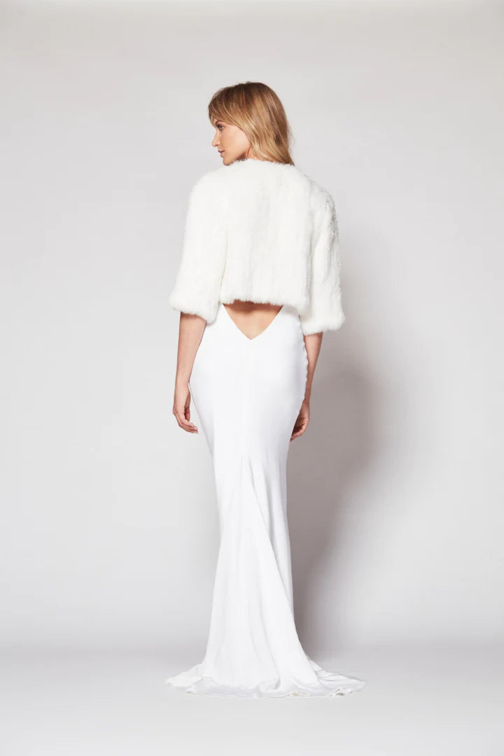 Back view of Laci fur jacket in snow. 3/4 Sleeves and cropped waist