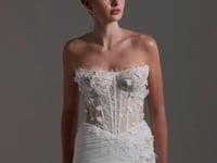 Fitted Bridal gown with floral lace scattered around the corseted bodice, basque waistline. 