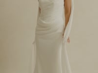 fitted crepe Bridal gown, strapless neckline, drapings around bust and hips. Paired with a scarf 