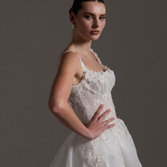 A-line Wedding gown featuring a square neckline, ballgown skirt, and lace. 