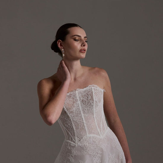 lace A-line wedding dress featuring a strapless neckline, exposed corset boning and unique waistline