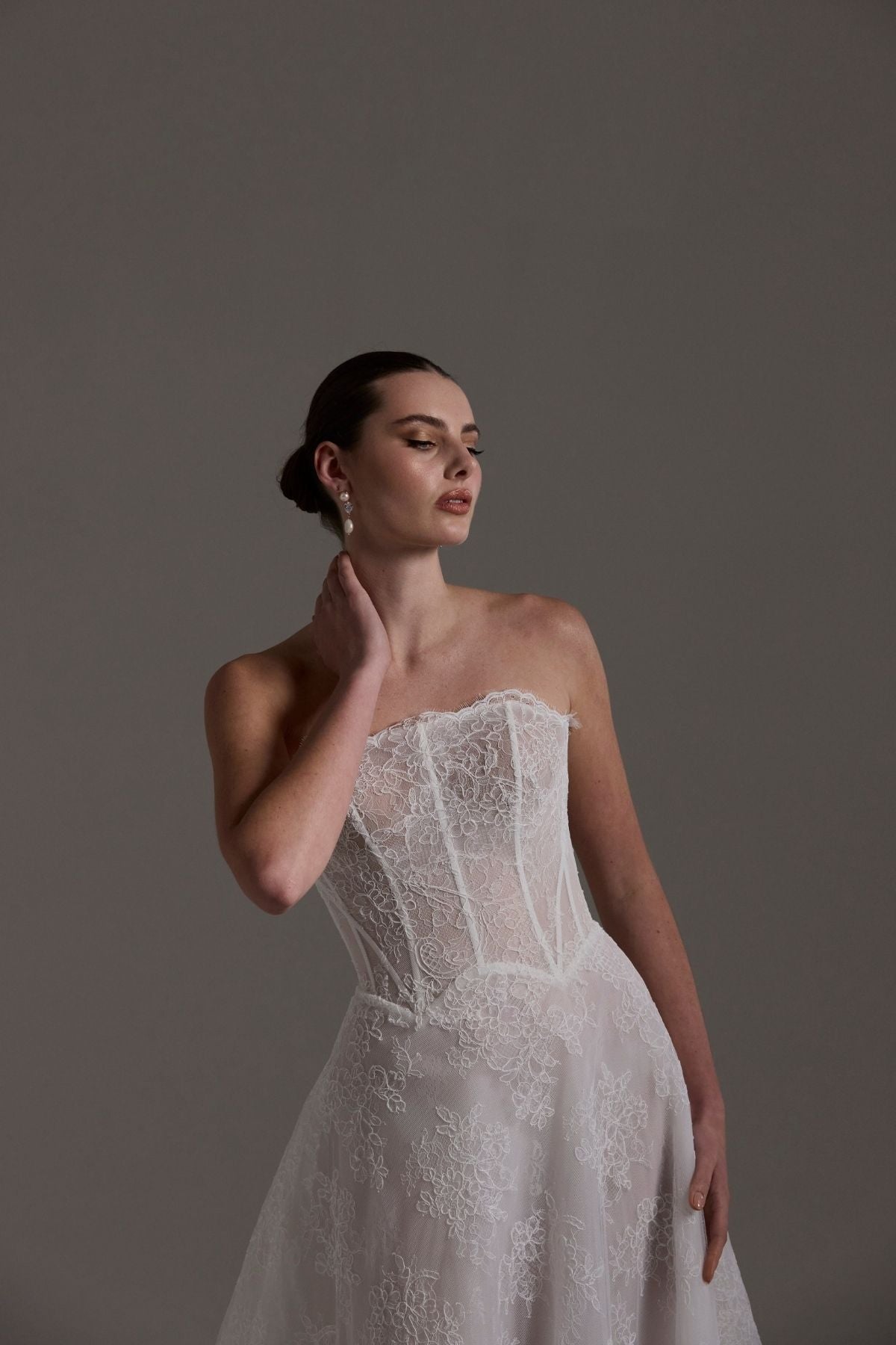 lace A-line wedding dress featuring a strapless neckline, exposed corset boning and unique waistline