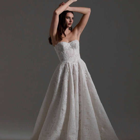A-line Wedding dress in floral Jacquard fabric with fitted sleeves and a strapless bodice 