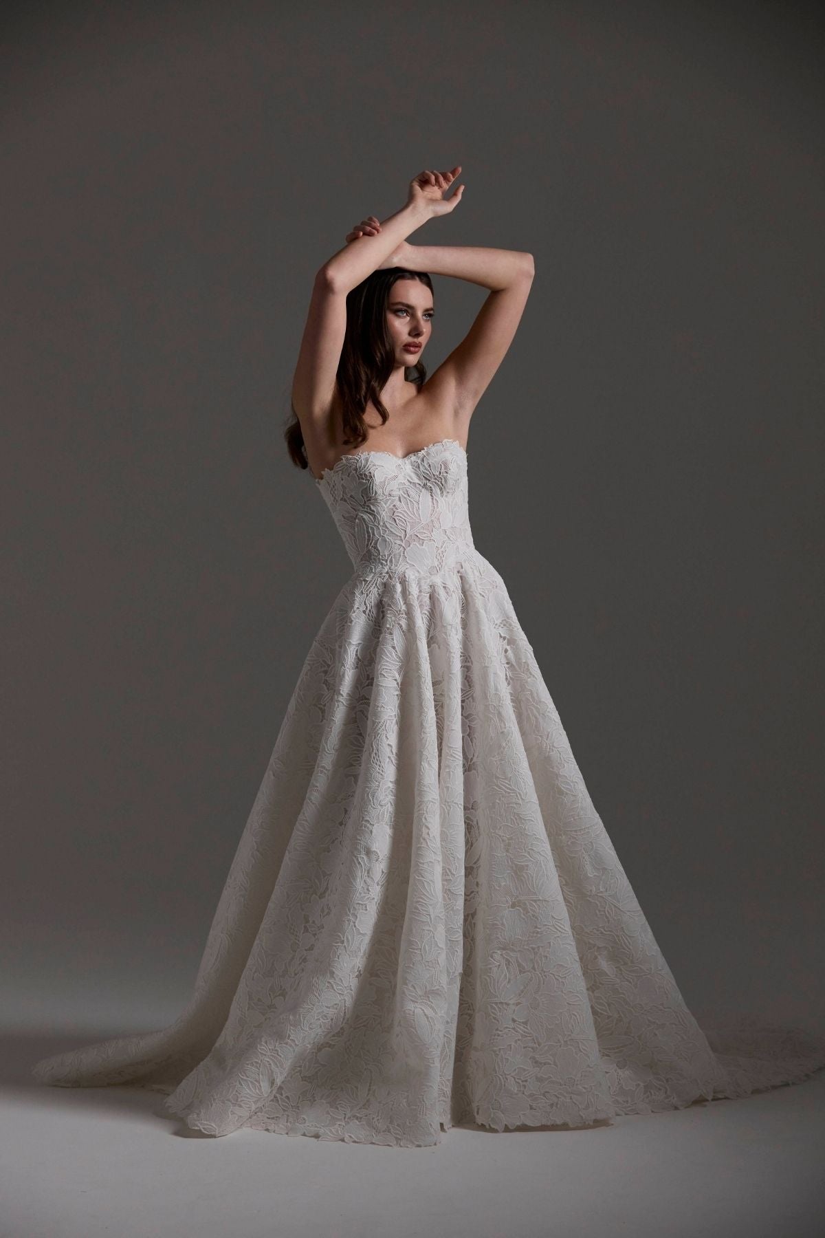 A-line Wedding dress in floral Jacquard fabric with fitted sleeves and a strapless bodice 