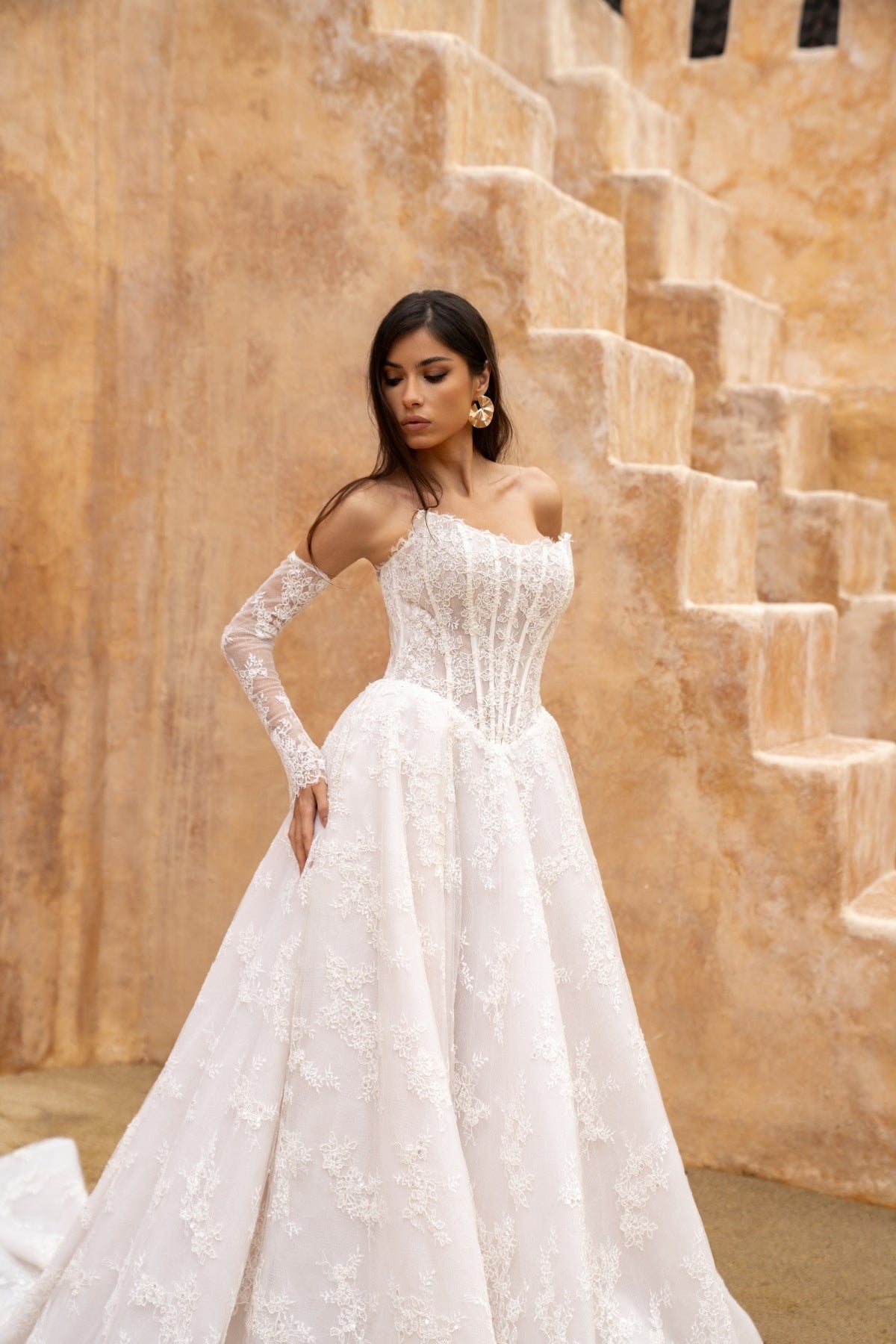 Lace A-line wedding dress with cat-eye neckline and basque waist. paired with fitted lace sleeves. 