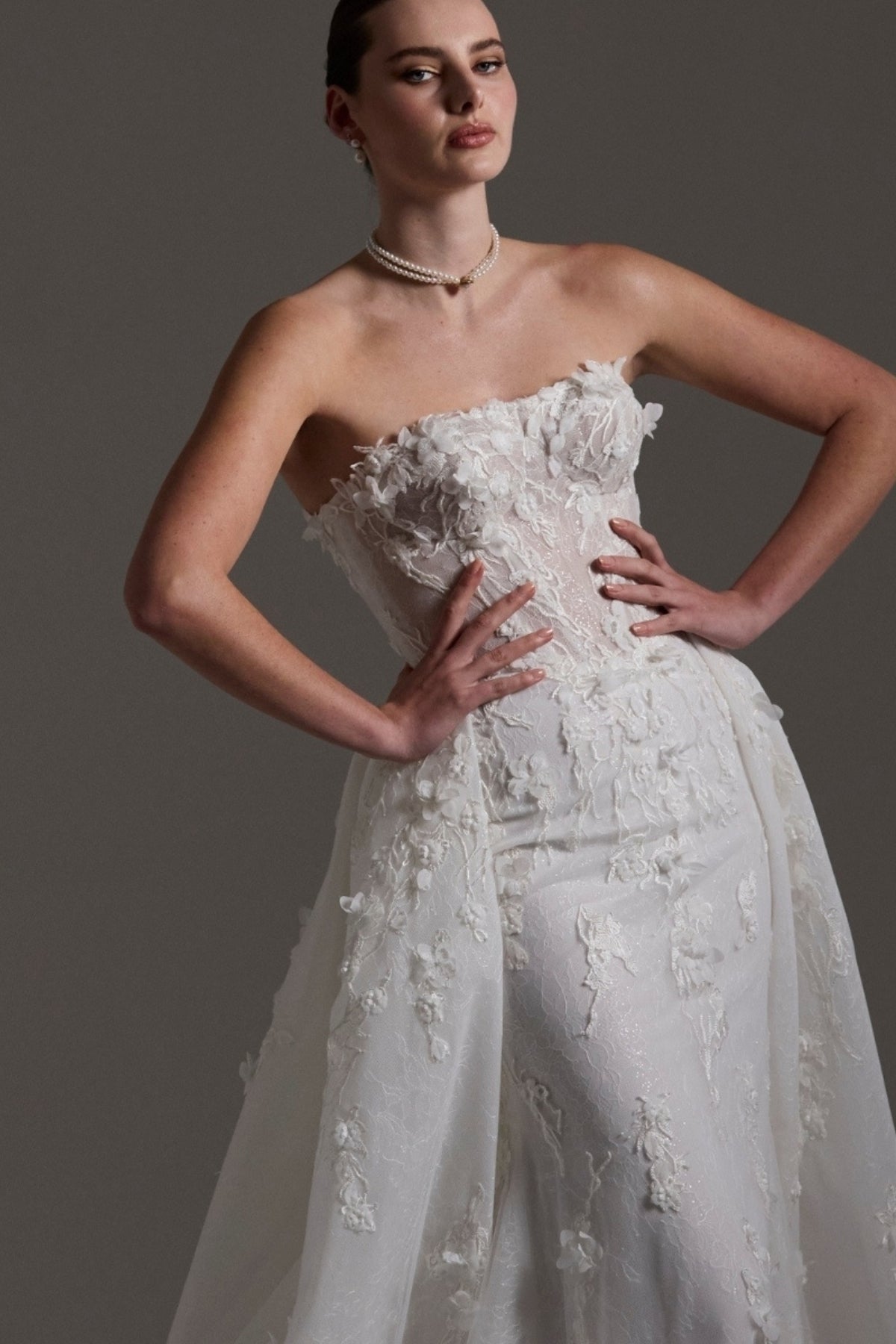 Fitted bridal gown with floral lace and strapless neckline 