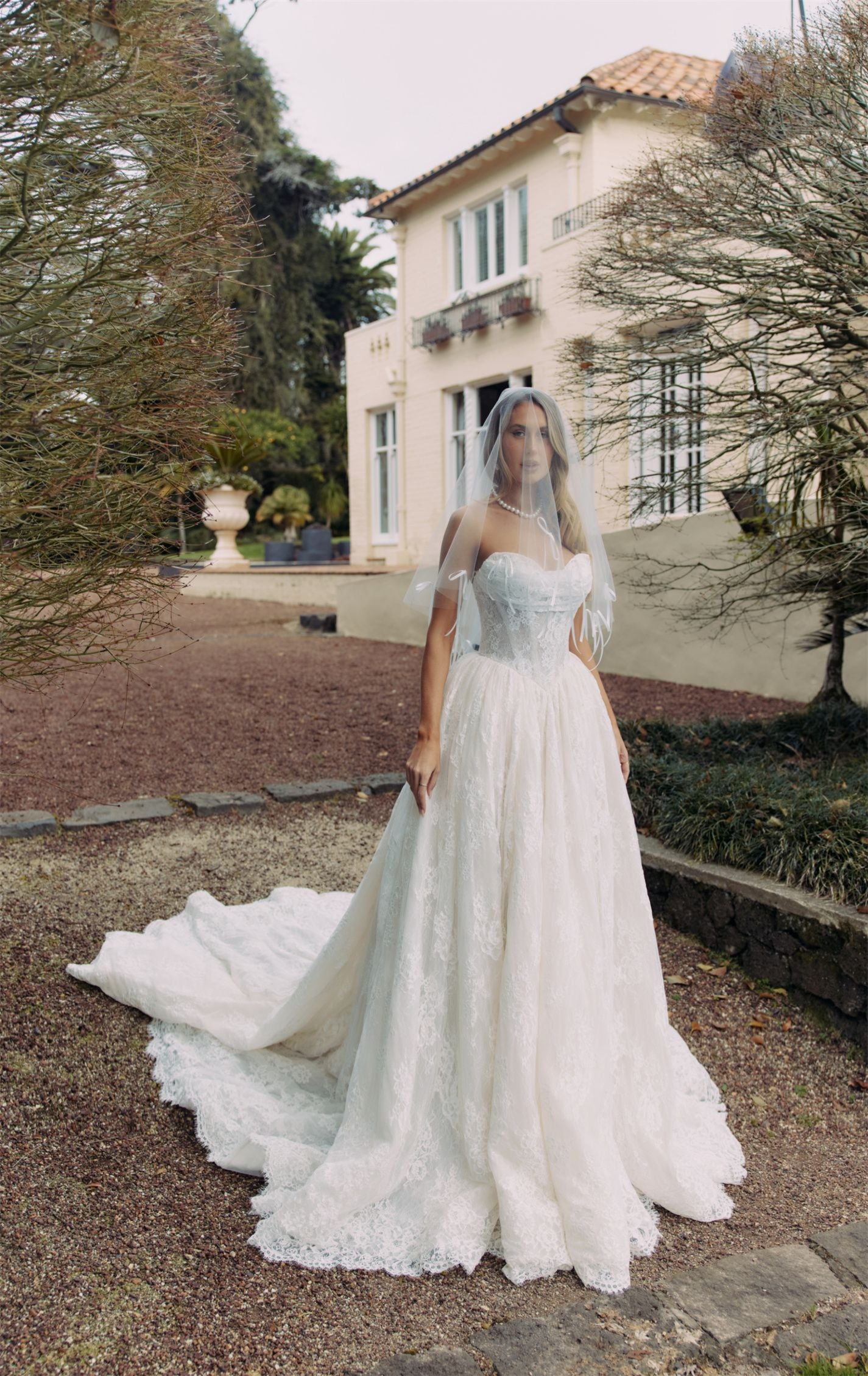 ELEANOR Bridal Gown - Wedding dress by Victoria Collection Jessica Couture. Featuring an A-line Princess ballgown with chapel train, and ruched corset Bodice with Chantilly lace. 