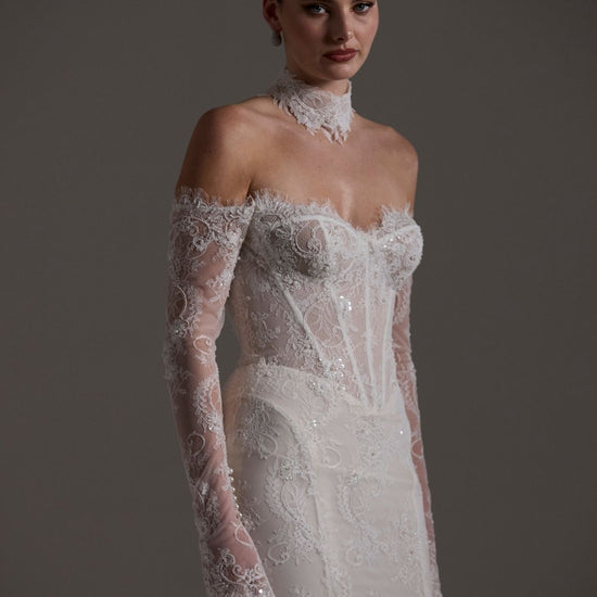 Fitted wedding gown featuring off-the-shoulder sleeves and neckline, vintage chantilly lace, basque waist, and lace choker. 