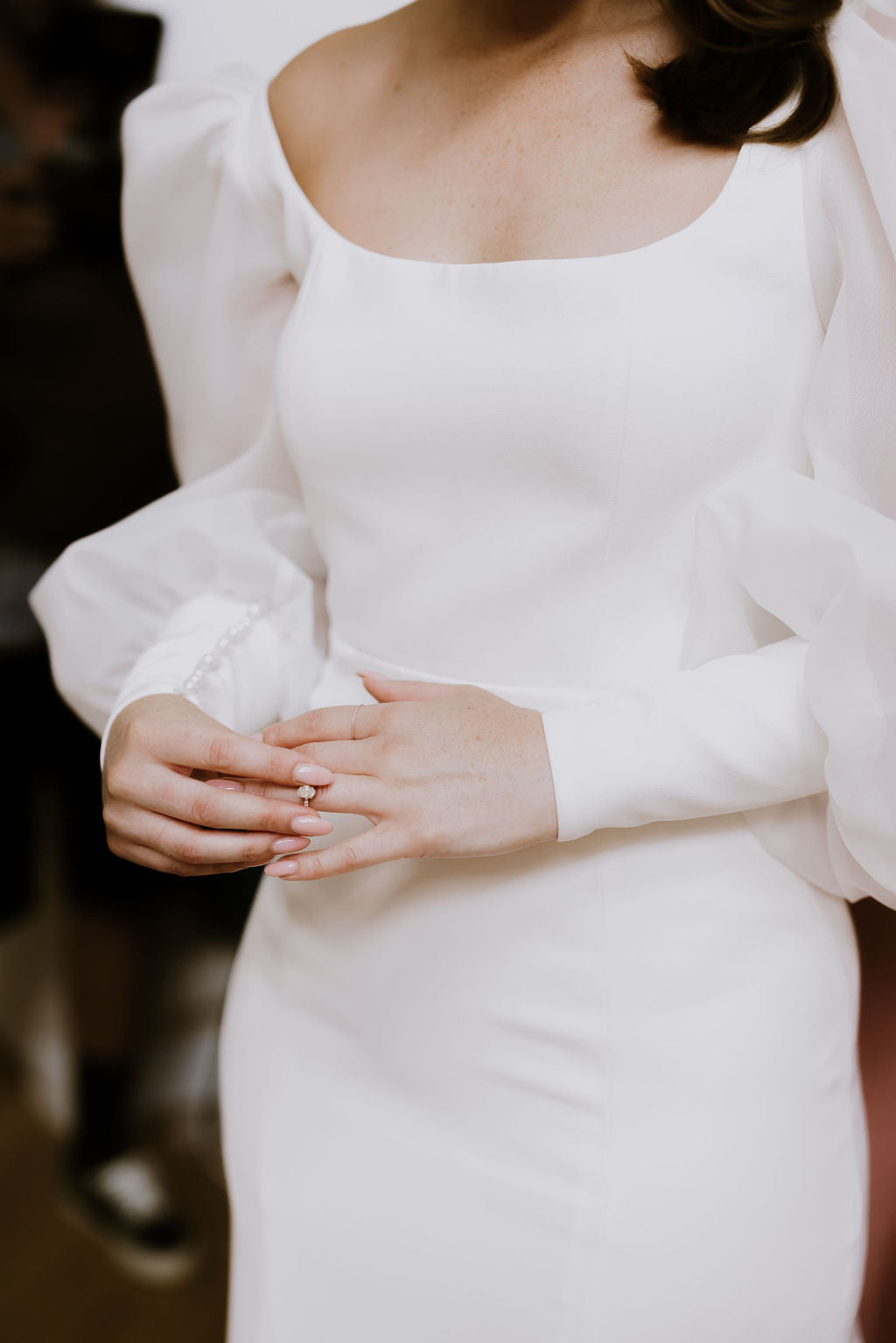 Statement long sleeve wedding dress with square neckline and bow feature.