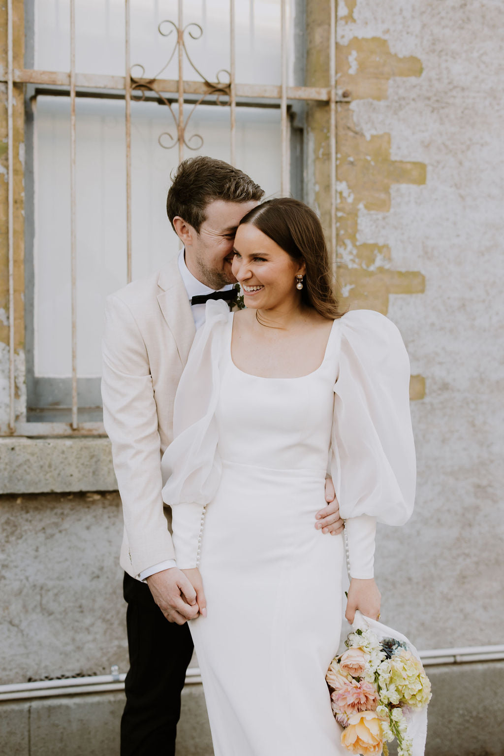 Statement long sleeve wedding dress with square neckline and bow feature.