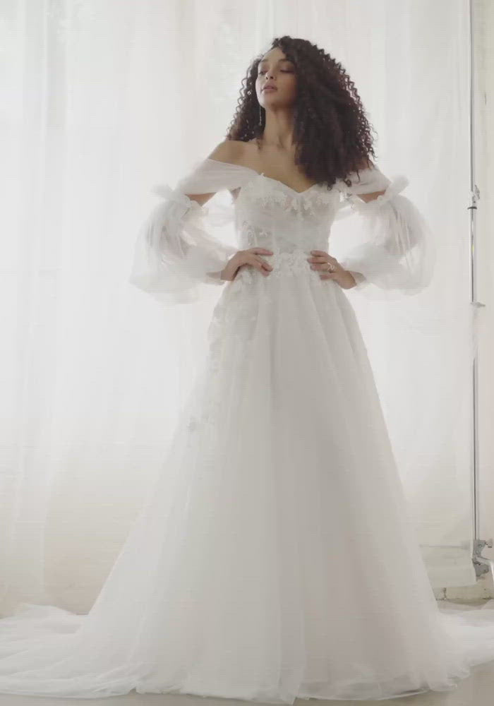 Video of model wearing Sky dress. A romantic tulle gown that floats as she moves.