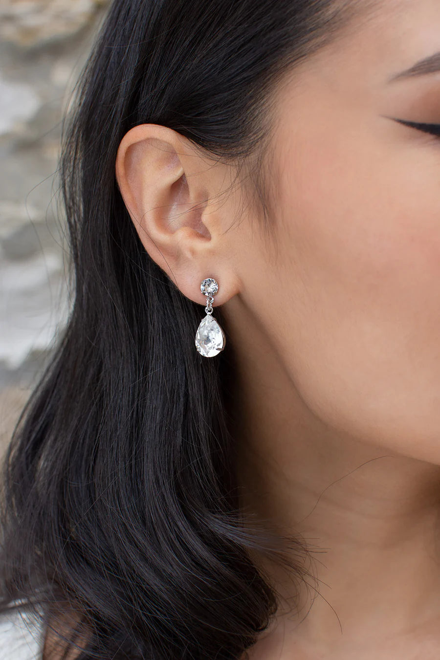 Rosemary earrings of round cubic zirconia stud with teardrop shaped diamante hanging from it. 