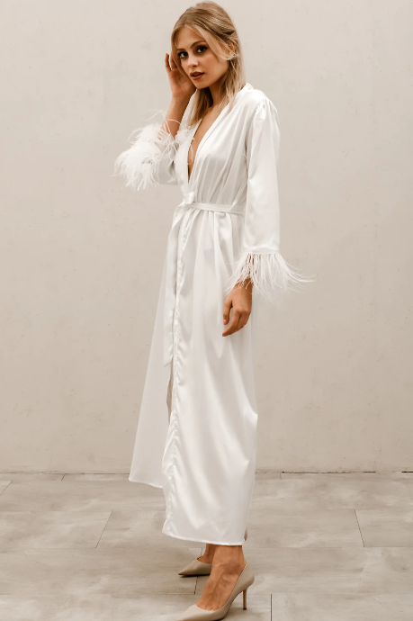 side view of full length satin look robe in ivory with feather cuffs