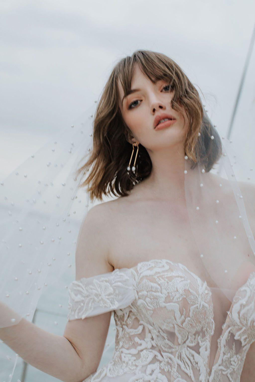 close up of bride wearing pearl Oli veil with plunging sweetheart neckline