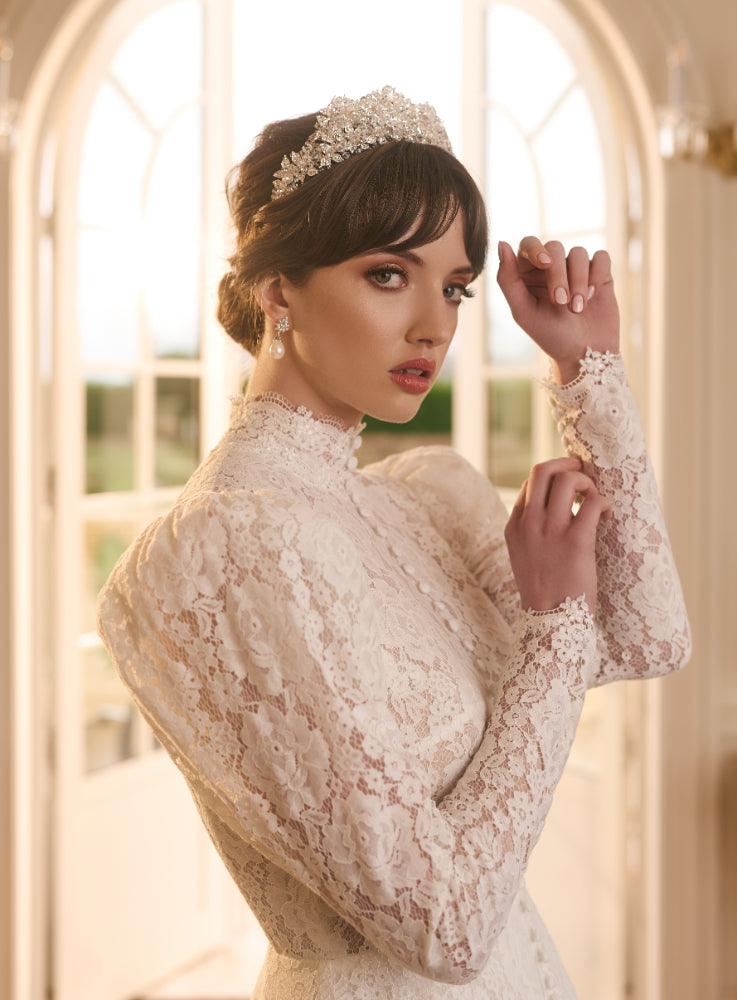 Close up of side of Tatyana bodice featuring sheer lace mutton sleeve and covered buttons running down the centre front of the gown.