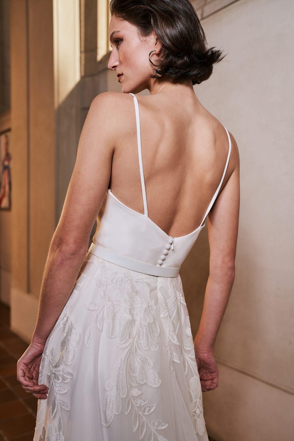 Model wearing Samara wedding dress with floral skirt from the Royal collection