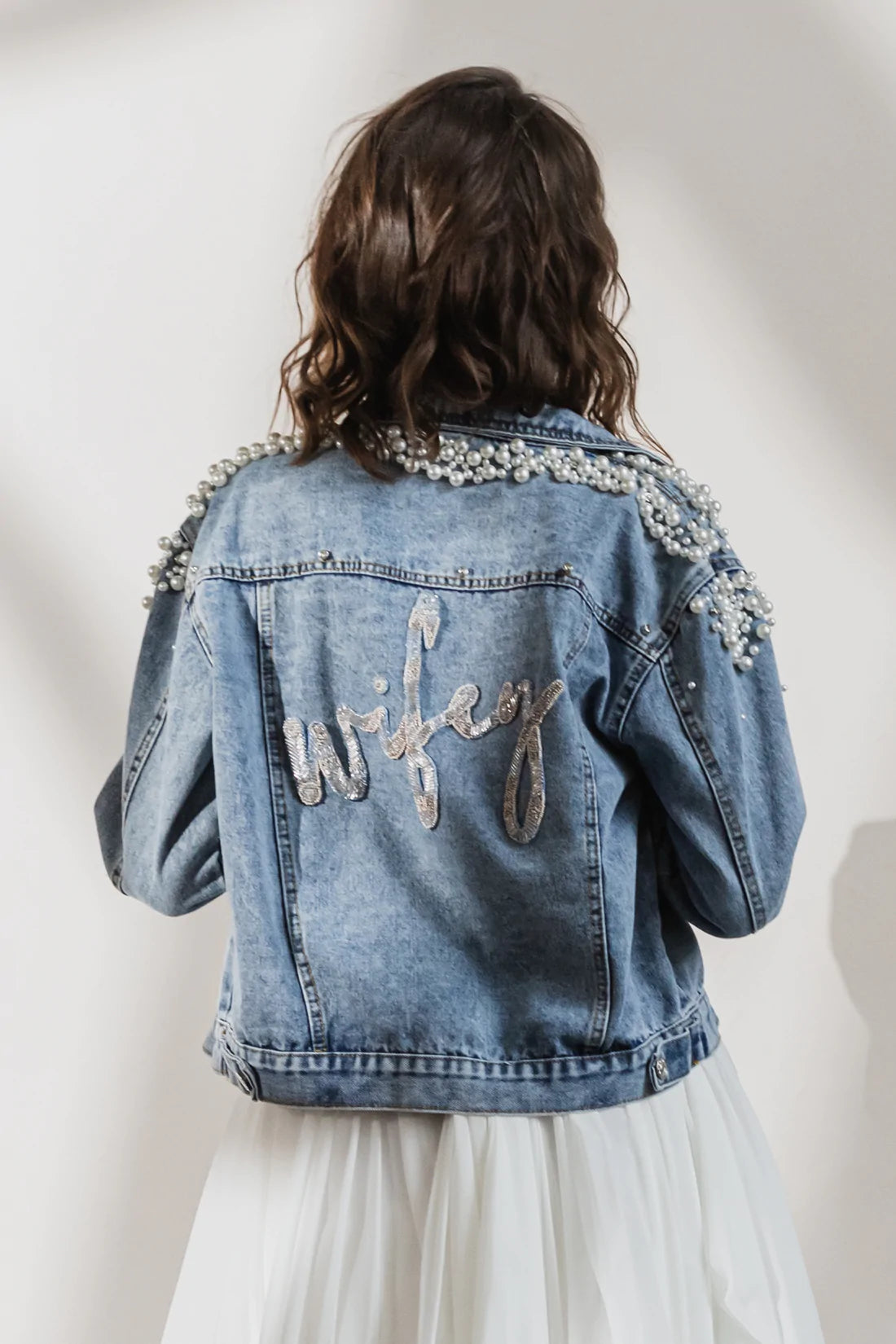 Blue denim jacket with pearl beads encrusted on shoulders and 'wifey' beaded on back