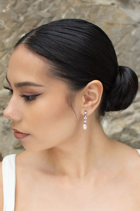 Cubic zirconia dangly earrings with oval shaped pearl at bottom.